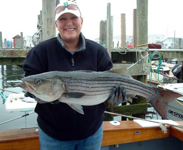 She is obviously pleased with this 37" 17lb Striped Bass.
