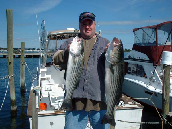 Zig holds two nice bass taken at Block Island
